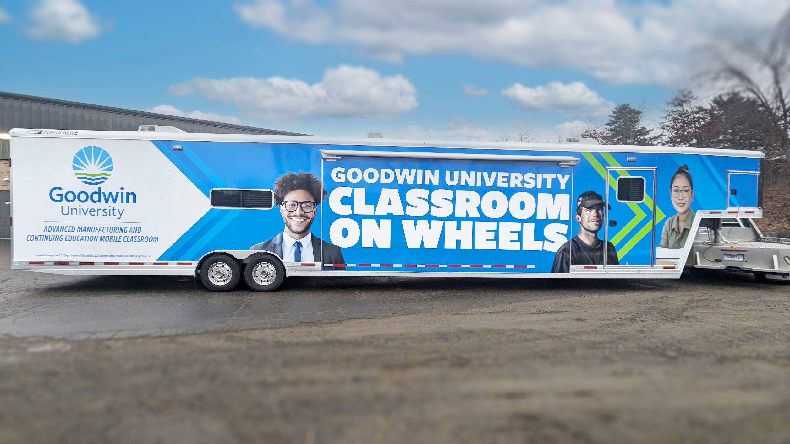 Photo showing the completed graphic wrap design after it was applied to the Goodwin University mobile classroom